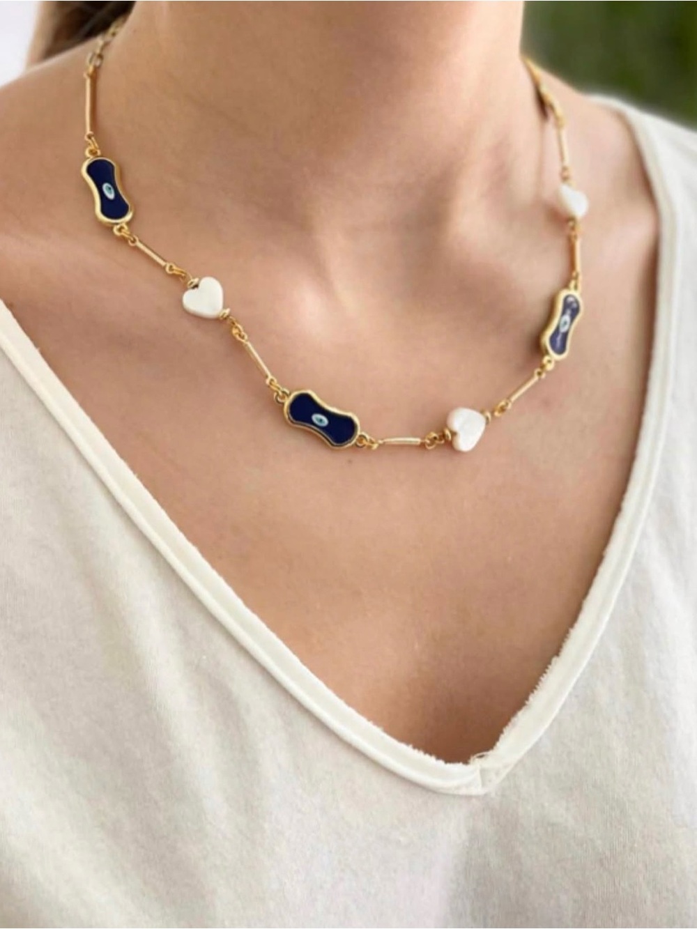 Gold-Tone Necklace with Blue Evil Eye Motifs and White Heart Beads